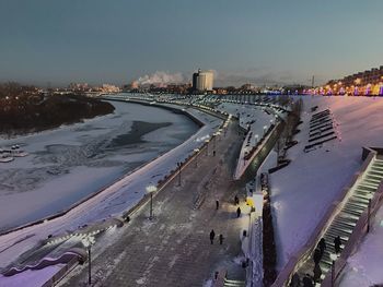 High angle view of river by city during winter