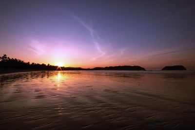 Scenic view of beach against dramatic sky