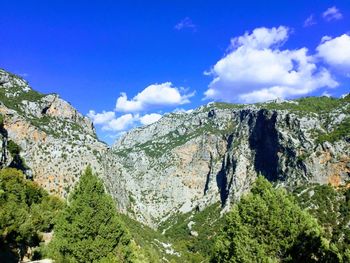 Scenic view of mountains against blue sky