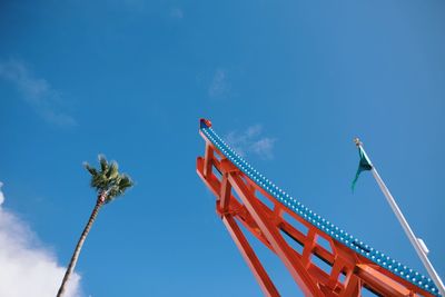 Low angle view of ferris wheel against blue sky