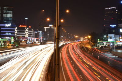 Light trails on road in city at night