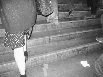 Low section of woman standing on tiled floor