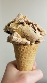 Close-up of hand holding ice cream cone