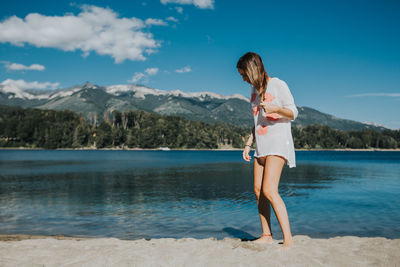 Woman with umbrella on lake