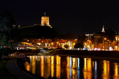 Illuminated buildings in city at night in vilniius