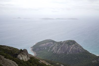 Scenic view of sea and mountains against sky