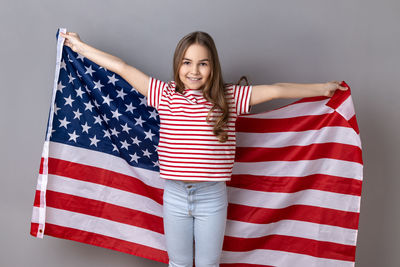 Portrait of young woman holding american flag