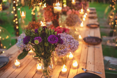 Close-up of illuminated flower vase on table