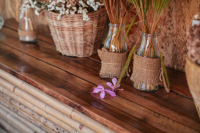 Close-up of flowers in basket on wooden table