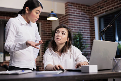 Businesswoman having discussion with colleague in office