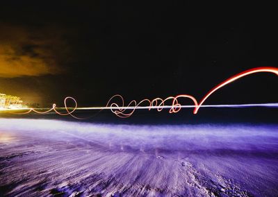 Light trails against sky at night