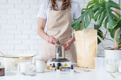 Midsection of woman preparing food on table