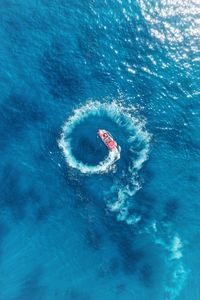 High angle aerial view of watersporst in sea