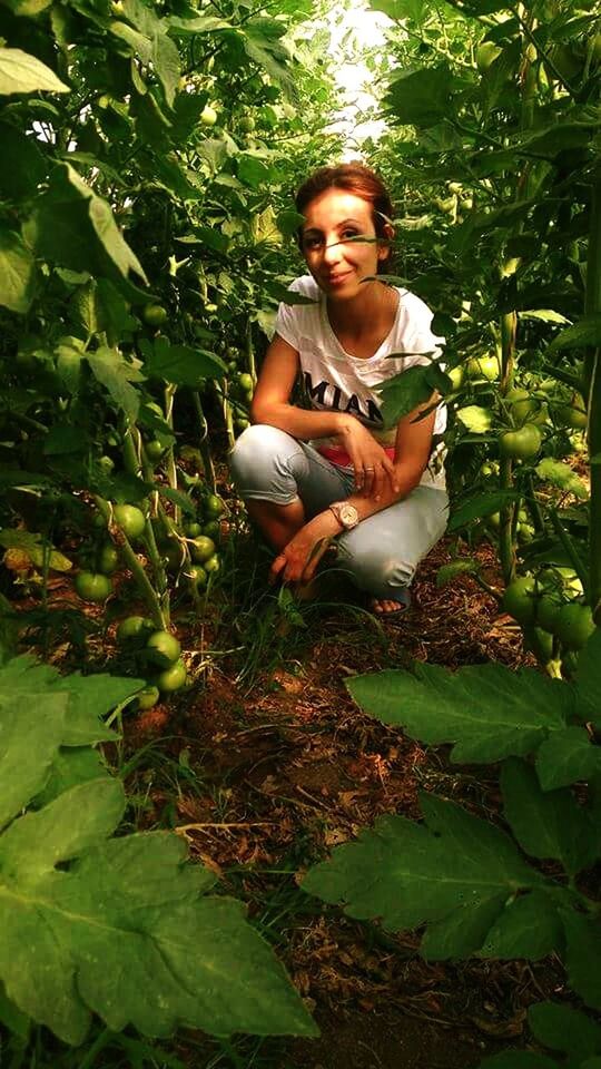 sitting, green color, full length, young adult, young women, leaf, person, growth, plant, casual clothing, holding, day, nature, vacations, outdoors, freshness, garden, leaves, weekend activities, beauty in nature