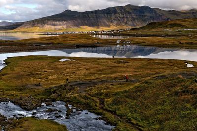 Scenic view of lake and mountains against sky