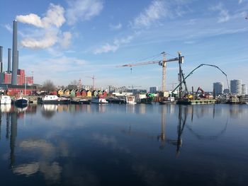 Scenic view of river against sky in city
