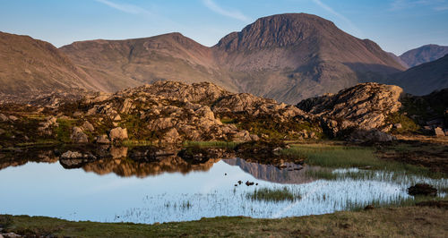 The evening light on the lakeland mountain of great gable reflecting in innominate tarn