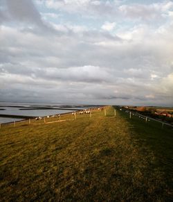 Scenic view of landscape against cloudy sky