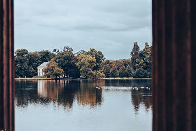 Reflection of trees in lake against sky