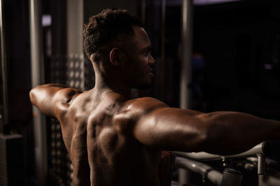 Side view of man exercising in gym