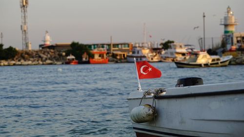 Boats moored in sea against sky