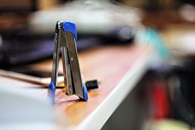 Close-up of stapler on table