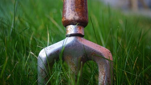 Close-up of rusty metal on field