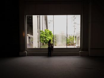 Man standing by window in building