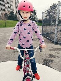 Portrait of cute girl riding bicycle at park