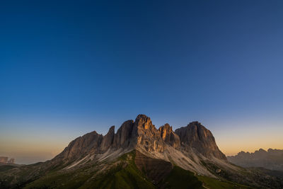 Scenic view of mountains against clear blue sky