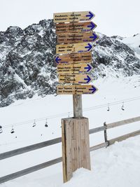 Text on snow covered landscape against sky