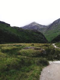 Scenic view of landscape and mountains against clear sky