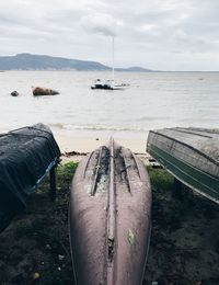 Close-up of boat moored on sea against sky