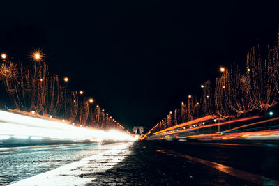 Illuminated light trails on road at night