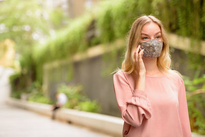 Portrait of woman holding a plant