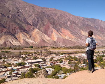 Rear view of man walking on mountain