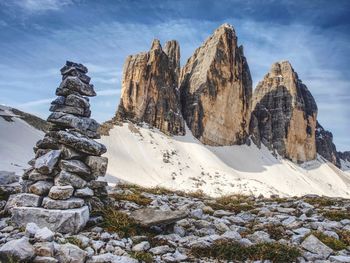 Stack of stones with mountain landscape along alps peaks, tre cime di lavaredo rocks in italy