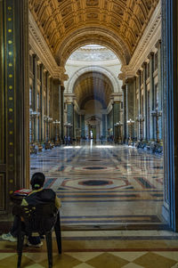 People sitting in corridor of building