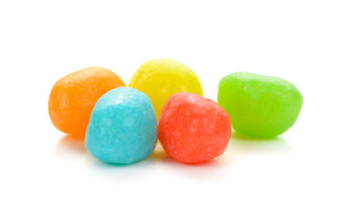 Close-up of multi colored candies against white background