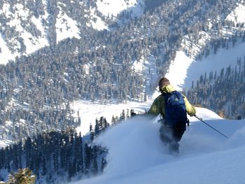 Rear view of woman on snowcapped mountain