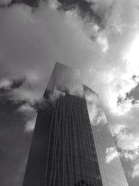 Low angle view of modern building against cloudy sky