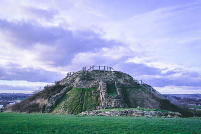 Old ruin on field against sky