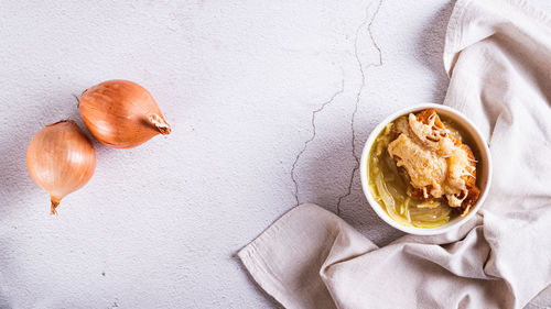 French onion soup with baked cheese bread in a bowl on the table top view web banner