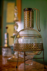 Close-up of lamp hanging on table at home