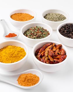 Close-up of food in bowls on white background