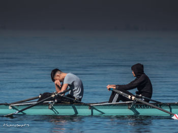 Friends on boat in sea against sky