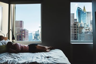 Woman sleeping on bed at home