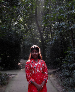 Young woman standing in forest