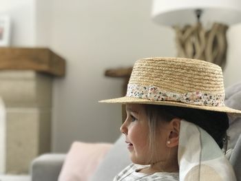 Close-up of girl wearing hat canotier at home