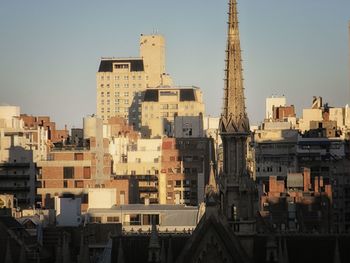 Buildings in city against sky